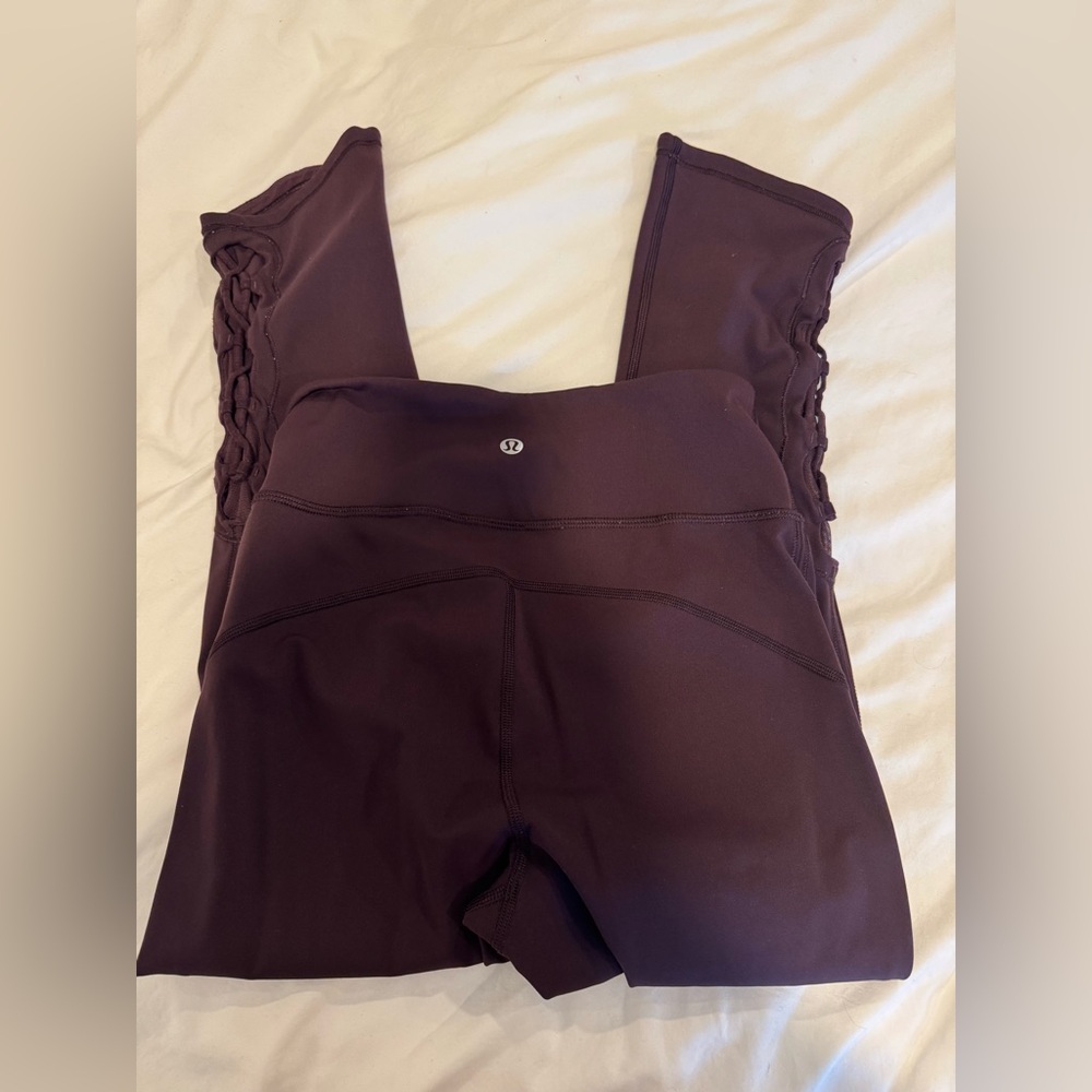 Lululemon size 4 plum leggings with cross cross detail on lower leg